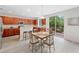 Bright kitchen with dark wood cabinets, breakfast bar, stainless appliances, and deck access at 6018 Oakdale Se Rd, Mableton, GA 30126