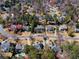 An aerial view showcases houses nestled among mature trees and manicured lawns at 65 Gatewood Dr, Marietta, GA 30068
