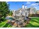 An inviting backyard featuring a pool, hot tub, lounge chairs, patio, and well-manicured lawn at 65 Gatewood Dr, Marietta, GA 30068