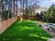 Large backyard with lush artificial turf, play set, and a fenced perimeter offering a private outdoor space at 65 Gatewood Dr, Marietta, GA 30068