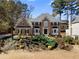 Charming brick home with a well-manicured lawn, mature trees, and inviting front entrance at 65 Gatewood Dr, Marietta, GA 30068