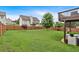 Large, well-maintained backyard with lush green grass and wood privacy fence at 218 Depot Ln, Dallas, GA 30157