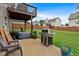 Patio area with a grill, hot tub, outdoor furniture, and a lush, green lawn at 218 Depot Ln, Dallas, GA 30157