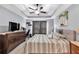 Spacious bedroom with a tray ceiling, ceiling fan, and a large dresser with a TV at 218 Depot Ln, Dallas, GA 30157