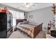 Cozy bedroom with a wooden bed frame, colorful bedding, and an organized wardrobe at 218 Depot Ln, Dallas, GA 30157