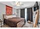 Bedroom featuring neutral decor, a ceiling fan, a comfortable bed, and dark window coverings at 218 Depot Ln, Dallas, GA 30157