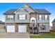 Charming two-story home featuring a two-car garage, stone accents, and a well-maintained front lawn at 218 Depot Ln, Dallas, GA 30157