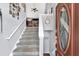 Inviting foyer with staircase, featuring a modern color palette and stylish front door with oval glass at 218 Depot Ln, Dallas, GA 30157