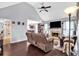 Cozy living room with hardwood floors, fireplace, and vaulted ceiling with ceiling fan at 218 Depot Ln, Dallas, GA 30157