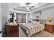 Serene main bedroom with tray ceilings, a ceiling fan, and soft, neutral décor at 218 Depot Ln, Dallas, GA 30157