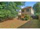 A backyard with lush trees, a deck, and a well-maintained lawn, perfect for outdoor activities at 2817 Lincoln Dr, Decatur, GA 30033