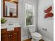 Powder room featuring wood vanity, updated fixtures, and large window offering plenty of light at 2817 Lincoln Dr, Decatur, GA 30033