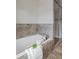 Bright bathroom with a soaking tub, tiled shower and neutral accents at 2817 Lincoln Dr, Decatur, GA 30033