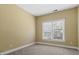 A simple bedroom with neutral walls, carpeting, and natural light from the window at 2817 Lincoln Dr, Decatur, GA 30033