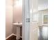 Powder room features a pedestal sink and wood flooring at 3271 Pennington Dr, Stonecrest, GA 30038