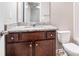 This bathroom features a granite countertop, dark wood cabinets, and a toilet at 3271 Pennington Dr, Stonecrest, GA 30038