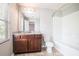 Bathroom featuring wood cabinets, granite countertops, and a shower-tub combo at 3271 Pennington Dr, Stonecrest, GA 30038