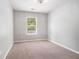 Carpeted bedroom with neutral walls and a window at 3271 Pennington Dr, Stonecrest, GA 30038