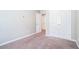 This bedroom includes carpet, neutral walls, and a closet with double doors at 3271 Pennington Dr, Stonecrest, GA 30038