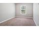 This bedroom features neutral walls, carpet, and a window with blinds at 3271 Pennington Dr, Stonecrest, GA 30038