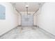 This garage is empty with a concrete floor and a white garage door at 3271 Pennington Dr, Stonecrest, GA 30038