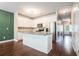 Bright kitchen features white cabinetry, stainless steel appliances, and a center island with granite countertops at 3271 Pennington Dr, Stonecrest, GA 30038