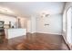 Open-concept living space with hardwood floors, kitchen island and modern lighting at 3271 Pennington Dr, Stonecrest, GA 30038