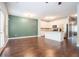 Open-concept living space with kitchen island, modern appliances and hardwood floors at 3271 Pennington Dr, Stonecrest, GA 30038