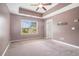 Bright main bedroom features carpet, a ceiling fan and a window offering natural light at 3271 Pennington Dr, Stonecrest, GA 30038