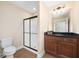 Cozy bathroom featuring a vanity with dark countertop and a walk-in shower with black trim at 328 Brookhaven Walk, Johns Creek, GA 30097