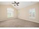 Bedroom with neutral carpet, three windows offering lots of light, and a ceiling fan at 328 Brookhaven Walk, Johns Creek, GA 30097