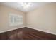 Bedroom featuring hardwood floors, light, neutral walls, and a window at 328 Brookhaven Walk, Johns Creek, GA 30097