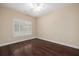 Bright bedroom with hardwood floors and a large window with shutters at 328 Brookhaven Walk, Johns Creek, GA 30097