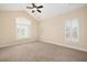 Bedroom with carpet, three windows with white blinds, and neutral walls at 328 Brookhaven Walk, Johns Creek, GA 30097