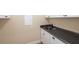 Functional butler's pantry with white cabinets and a dark countertop at 328 Brookhaven Walk, Johns Creek, GA 30097