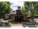 Exterior shot of the community clubhouse framed by mature trees, flowering shrubs and beautiful landscaping at 328 Brookhaven Walk, Johns Creek, GA 30097
