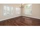 Elegant dining room with hardwood floors, plantation shutters, and a chandelier at 328 Brookhaven Walk, Johns Creek, GA 30097