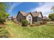 Beautiful home with manicured lawn and landscaping, a stone facade, and an enclosed sunroom at 328 Brookhaven Walk, Johns Creek, GA 30097