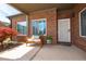 Inviting front porch featuring a cozy bench, decorative pillows, and a colorful Japanese maple tree at 328 Brookhaven Walk, Johns Creek, GA 30097