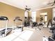 Bright home gym with various exercise machines, mirrors, and a ceiling fan at 328 Brookhaven Walk, Johns Creek, GA 30097