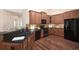 Well-equipped kitchen featuring dark granite countertops, wood cabinetry, and stainless steel appliances at 328 Brookhaven Walk, Johns Creek, GA 30097