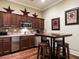 This well-lit kitchenette has stainless steel appliances, and a table with seating for four at 328 Brookhaven Walk, Johns Creek, GA 30097