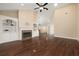 Open living room with hardwood floors, fireplace and built-in shelves, bright neutral paint, and vaulted ceilings at 328 Brookhaven Walk, Johns Creek, GA 30097