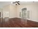 Bright living room with hardwood floors, tall ceilings, and glass french doors to the sunroom at 328 Brookhaven Walk, Johns Creek, GA 30097