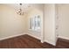 Bright living room featuring beautiful hardwood floors, white trim, and a modern chandelier at 328 Brookhaven Walk, Johns Creek, GA 30097