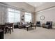 Bright living room with neutral tones, large windows, comfortable seating, and elegant decor at 328 Brookhaven Walk, Johns Creek, GA 30097