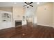 Open-concept living room with vaulted ceiling, hardwood floors, and built-in shelving around a fireplace at 328 Brookhaven Walk, Johns Creek, GA 30097