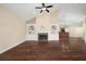 Spacious living room with hardwood floors, fireplace, and built-in shelving, creating an inviting atmosphere at 328 Brookhaven Walk, Johns Creek, GA 30097