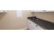 Functional wet bar area featuring white cabinets, a dark countertop, and a stainless steel sink at 328 Brookhaven Walk, Johns Creek, GA 30097
