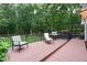 Relax on this spacious deck featuring a lounge chair, dining chair, and an outdoor grill at 3750 Cannonwolde Dr, Snellville, GA 30039